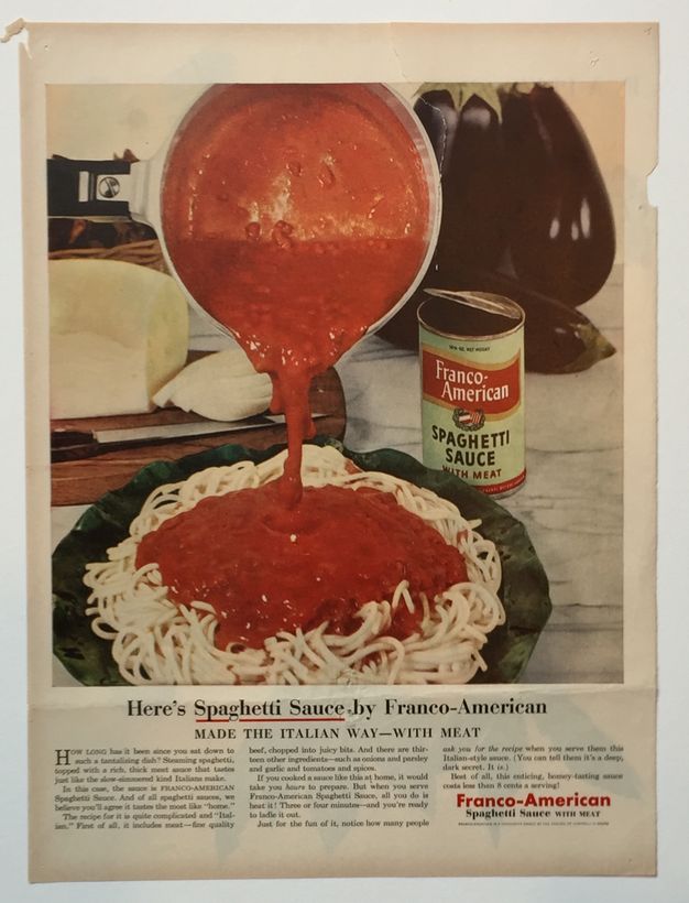 Ad. Vivid red tomato sauce pours out of a pan and onto a pile of cooked spaghetti. An open can, a loaf of bread, and eggplants are on the marble counter behind the plate. Text below begins with, “Here’s Spaghetti Sauce by Franco-American Made the Italian Way – with Meat”.